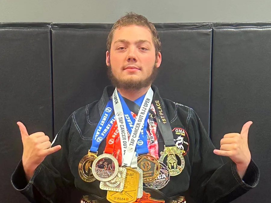 GMA Jiu Jitsu NAGA champion with medals and title belt